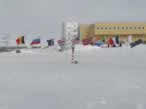 The ceremonial South Pole marker, encircled with flags representing the member nations of the Antarctic Treaty.